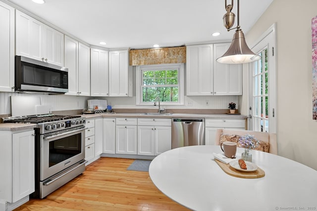 49 Bear Hills Rd, Newtown, CT 06470 - kitchen with stainless steel appliances, white cabinets, light countertops, light wood-style flooring, and recessed lighting