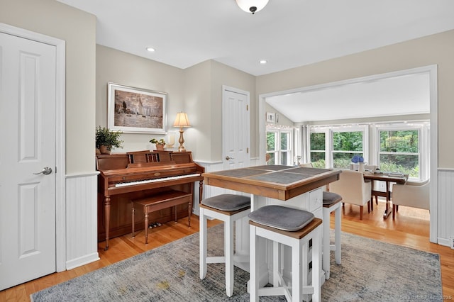 49 Bear Hills Rd, Newtown, CT 06470 - kitchen with tile counters, a wainscoted wall, a breakfast bar, and light wood finished floors