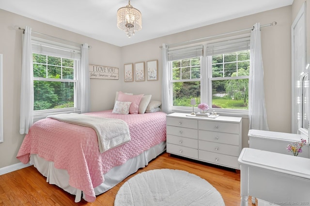 49 Bear Hills Rd, Newtown, CT 06470 - bedroom featuring multiple windows, light wood-style flooring, and a chandelier