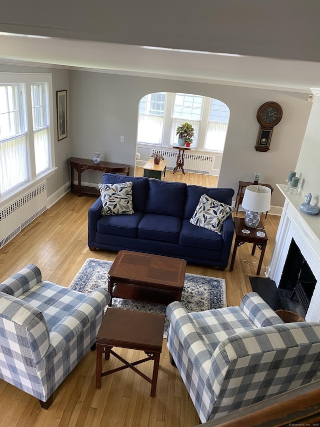 1248 Valley Rd, Fairfield, CT 06825 - living room with radiator, wood finished floors, baseboards, and a fireplace