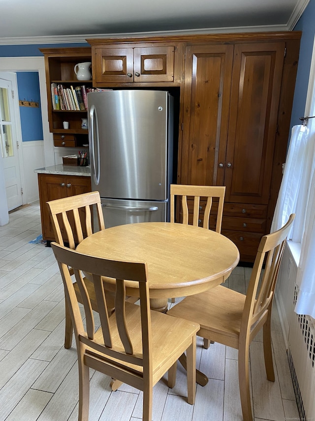 1248 Valley Rd, Fairfield, CT 06825 - dining area featuring ornamental molding, light wood-type flooring, a wainscoted wall, and radiator heating unit