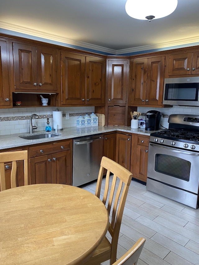 1248 Valley Rd, Fairfield, CT 06825 - kitchen featuring stainless steel appliances, a sink, decorative backsplash, and light wood-type flooring