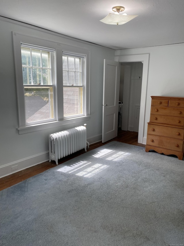 1248 Valley Rd, Fairfield, CT 06825 - carpeted bedroom featuring radiator, baseboards, and wood finished floors