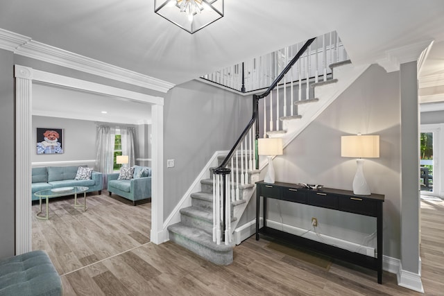 8A Russett Rd, Newtown, CT 06482 - staircase featuring wood finished floors, baseboards, ornamental molding, and a chandelier