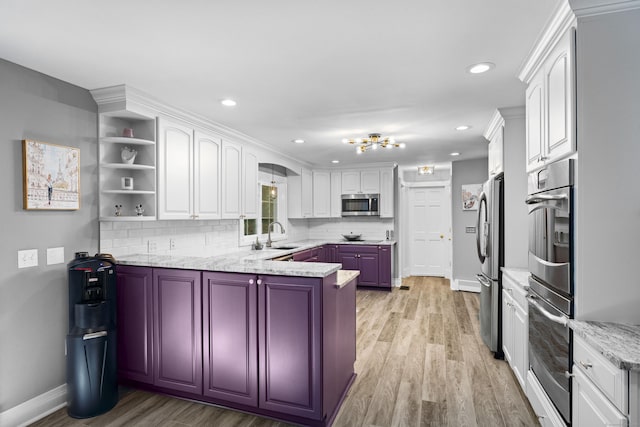 8A Russett Rd, Newtown, CT 06482 - kitchen featuring appliances with stainless steel finishes, baseboards, a peninsula, light wood-style floors, and white cabinetry