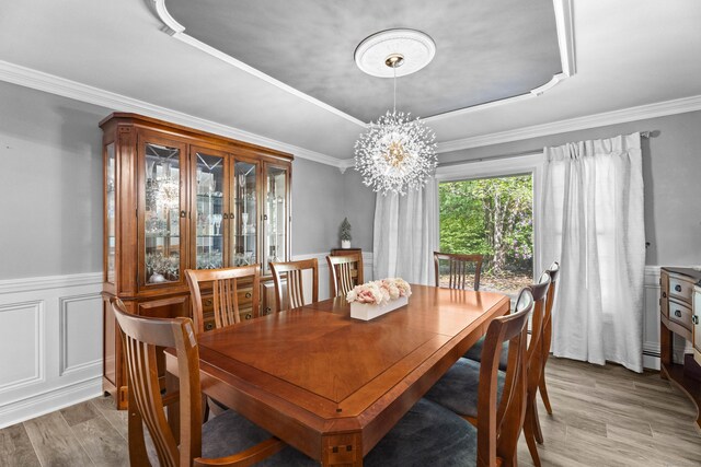 8A Russett Rd, Newtown, CT 06482 - dining room with a tray ceiling, a chandelier, wood finished floors, ornamental molding, and a wainscoted wall