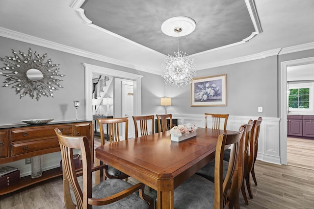 8A Russett Rd, Newtown, CT 06482 - dining room featuring a tray ceiling, light wood-style flooring, crown molding, stairway, and a chandelier
