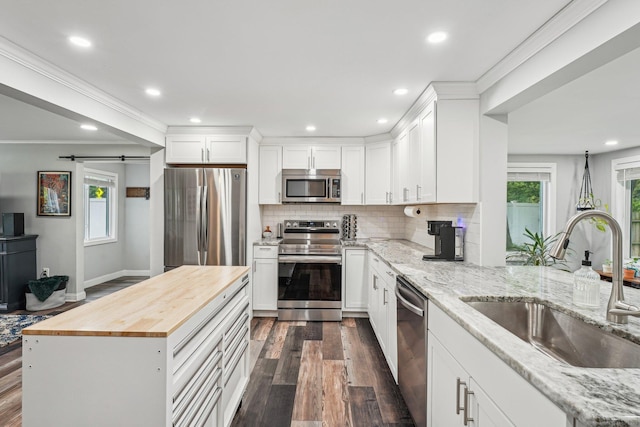 288 Robbins Ave, Newington, CT 06111 - kitchen with stainless steel appliances, a sink, butcher block countertops, dark wood-type flooring, and plenty of natural light