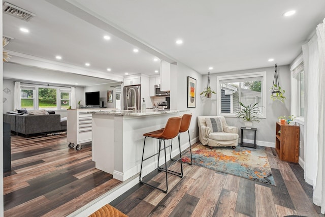 288 Robbins Ave, Newington, CT 06111 - kitchen with open floor plan, stainless steel microwave, white cabinets, dark wood-style floors, and recessed lighting