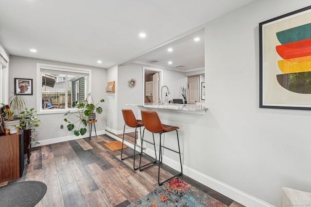288 Robbins Ave, Newington, CT 06111 - kitchen with a breakfast bar area, dark wood finished floors, baseboards, recessed lighting, and light stone countertops