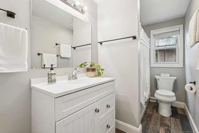 288 Robbins Ave, Newington, CT 06111 - full bath with wood finished floors, vanity, toilet, baseboards, and a shower with curtain