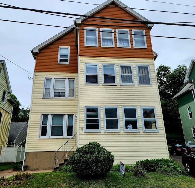 view of front of home featuring fence
