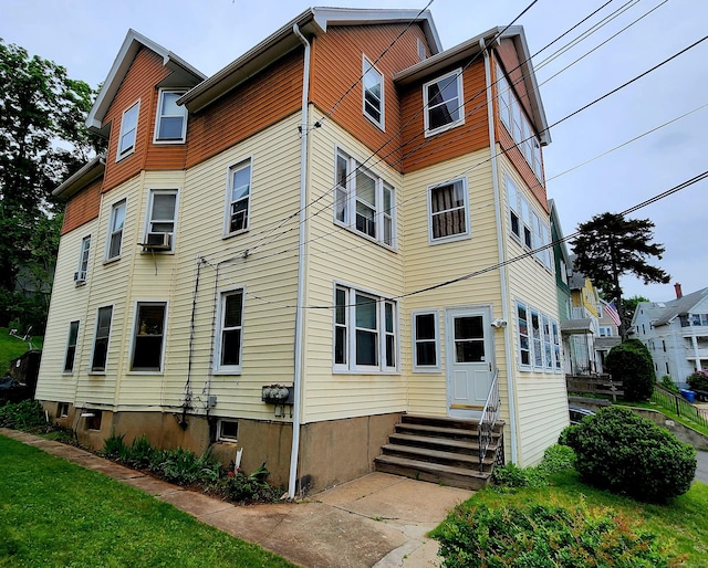 back of property with entry steps and cooling unit