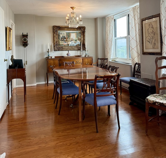 1 Strawberry Hill Ct Apt 6F, Stamford, CT 06902 - dining space featuring a chandelier, wood finished floors, and baseboards