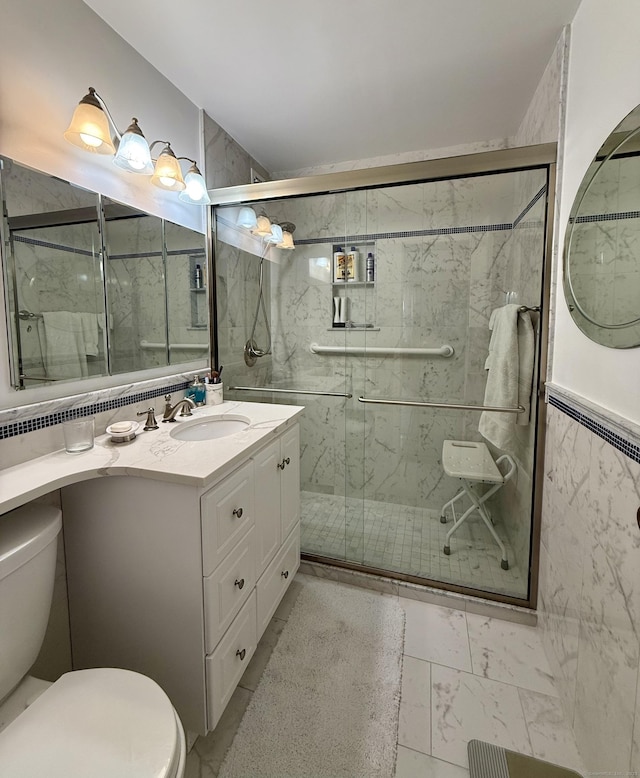 1 Strawberry Hill Ct Apt 6F, Stamford, CT 06902 - full bathroom with toilet, marble look tile flooring, a marble finish shower, and vanity
