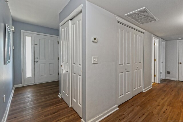 3250 Fairfield Ave Apt 302, Bridgeport, CT 06605 - foyer entrance with baseboards and dark wood-style floors