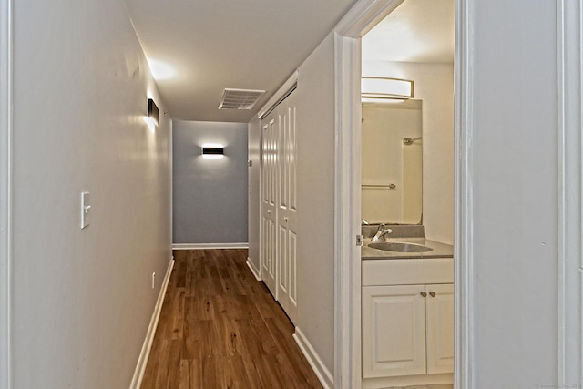 3250 Fairfield Ave Apt 302, Bridgeport, CT 06605 - corridor featuring a sink, dark wood finished floors, and baseboards