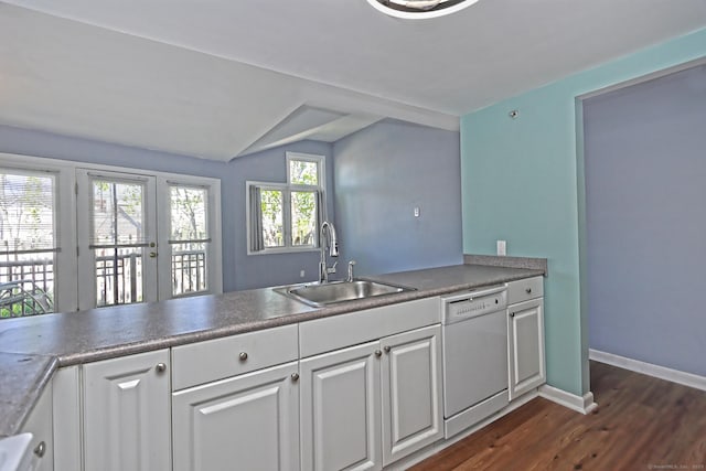 3250 Fairfield Ave Apt 302, Bridgeport, CT 06605 - kitchen featuring white dishwasher, a sink, dark wood-style floors, white cabinets, and vaulted ceiling