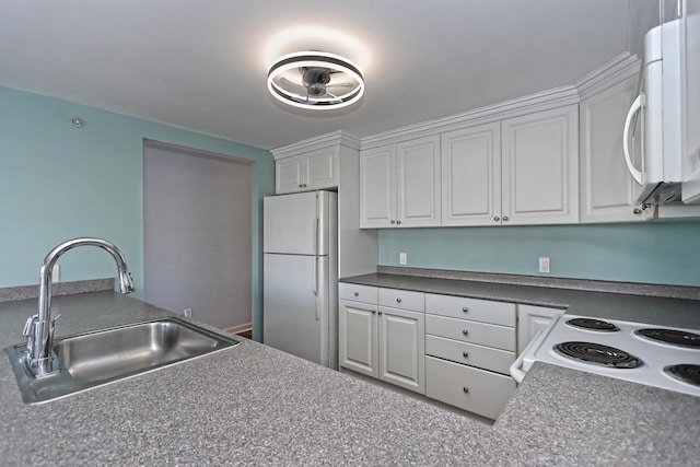 3250 Fairfield Ave Apt 302, Bridgeport, CT 06605 - kitchen featuring white appliances, a sink, white cabinetry, and dark countertops