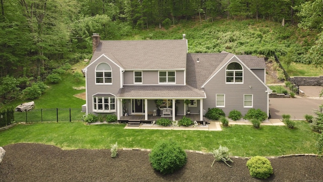 130 Wildewood Run, Bristol, CT 06010 - view of front of home with roof with shingles, a chimney, a view of trees, and a porch