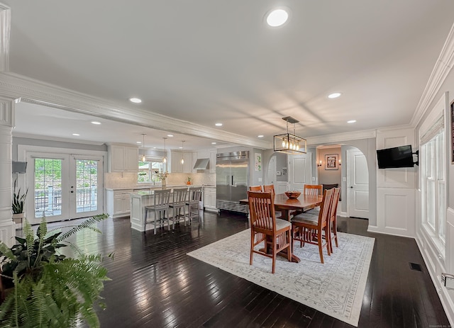 130 Wildewood Run, Bristol, CT 06010 - dining room featuring dark wood finished floors, ornamental molding, recessed lighting, arched walkways, and french doors