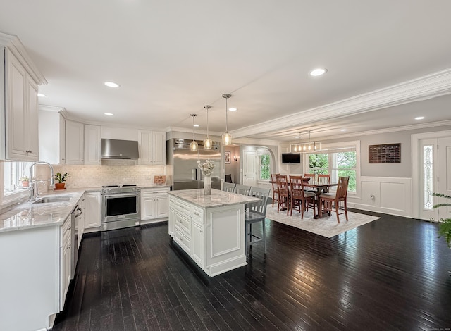 130 Wildewood Run, Bristol, CT 06010 - kitchen featuring stainless steel appliances, a sink, exhaust hood, ornamental molding, and white cabinetry