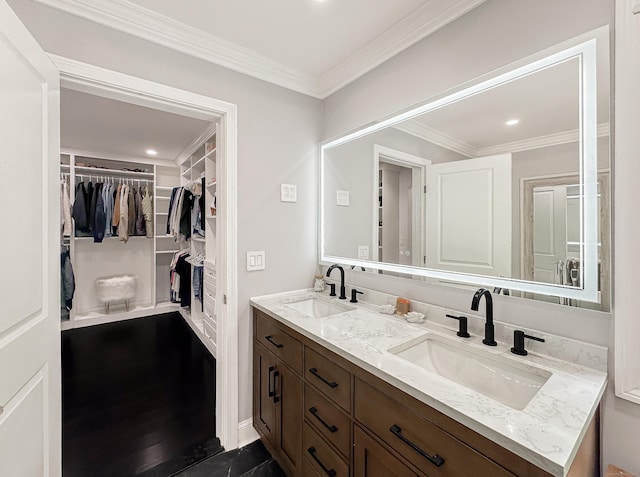 130 Wildewood Run, Bristol, CT 06010 - bathroom with double vanity, crown molding, a spacious closet, and recessed lighting