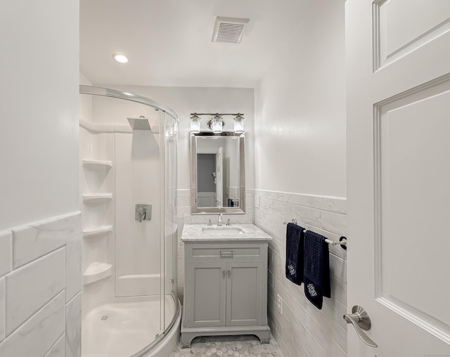 130 Wildewood Run, Bristol, CT 06010 - bathroom featuring a shower stall, tile walls, vanity, and a wainscoted wall