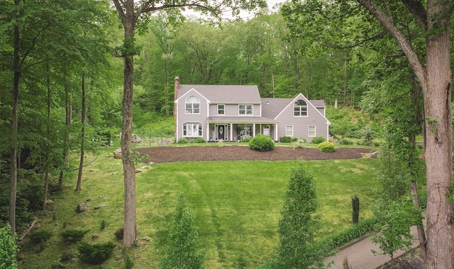 130 Wildewood Run, Bristol, CT 06010 - view of front of home featuring a chimney, a front lawn, a porch, and a forest view