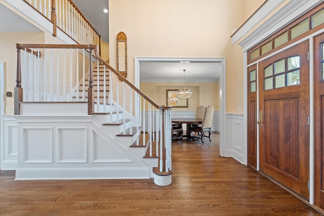 24 N Racebrook Rd, Woodbridge, CT 06525 - foyer with ornamental molding, stairs, a decorative wall, wood finished floors, and a chandelier