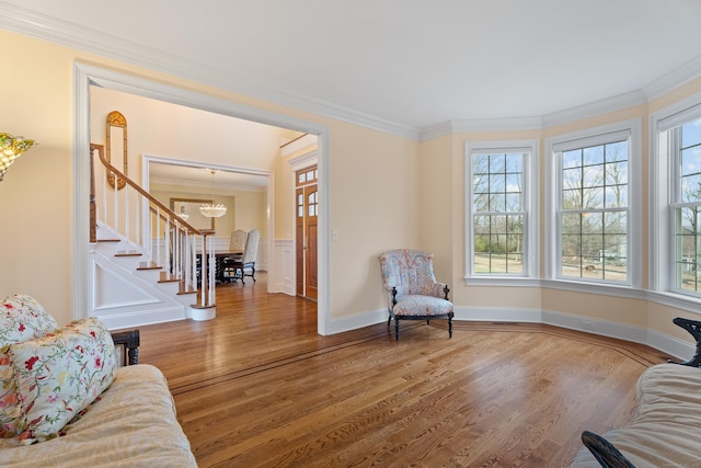 24 N Racebrook Rd, Woodbridge, CT 06525 - living room featuring stairs, wood finished floors, a chandelier, healthy amount of natural light, and ornamental molding