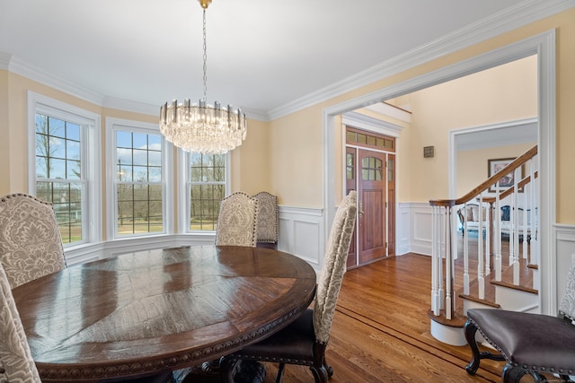 24 N Racebrook Rd, Woodbridge, CT 06525 - dining space with a chandelier, stairs, wood finished floors, crown molding, and wainscoting