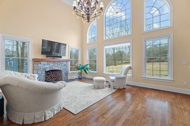 24 N Racebrook Rd, Woodbridge, CT 06525 - living room with a chandelier, a fireplace, plenty of natural light, a high ceiling, and wood finished floors
