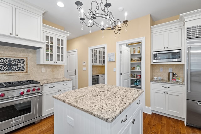 24 N Racebrook Rd, Woodbridge, CT 06525 - kitchen featuring built in appliances, backsplash, white cabinetry, a kitchen island, and recessed lighting