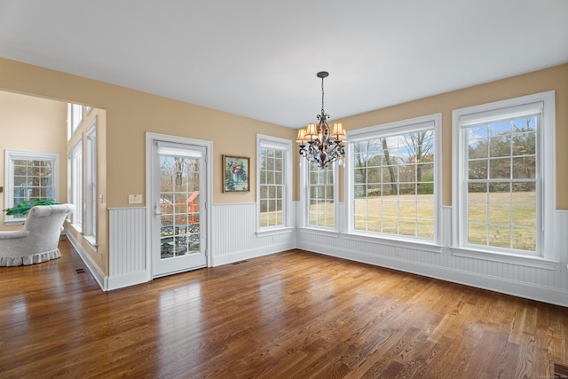 24 N Racebrook Rd, Woodbridge, CT 06525 - unfurnished dining area with wood finished floors, a chandelier, wainscoting, and plenty of natural light