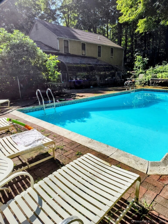 15 Packer Brook Rd, Redding, CT 06896 - outdoor pool with view of wooded area and a patio