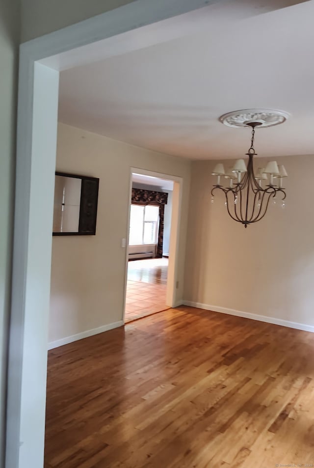15 Packer Brook Rd, Redding, CT 06896 - empty room featuring light wood-style flooring, a chandelier, and baseboards