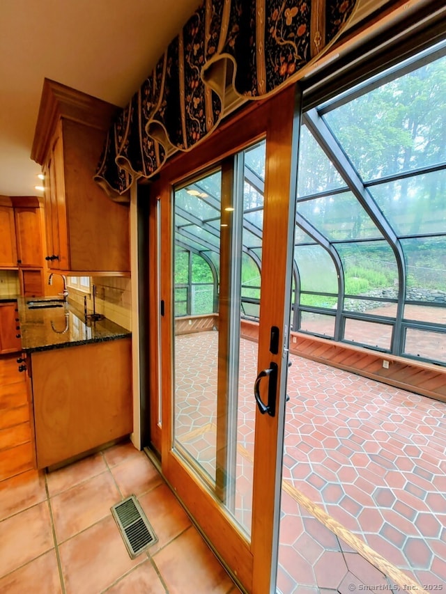 15 Packer Brook Rd, Redding, CT 06896 - doorway to outside featuring a sunroom, light tile patterned floors, and a sink