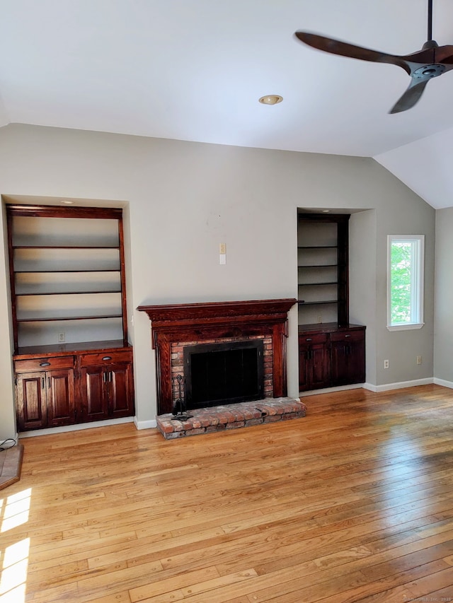15 Packer Brook Rd, Redding, CT 06896 - unfurnished living room with vaulted ceiling, light wood finished floors, a ceiling fan, a brick fireplace, and baseboards