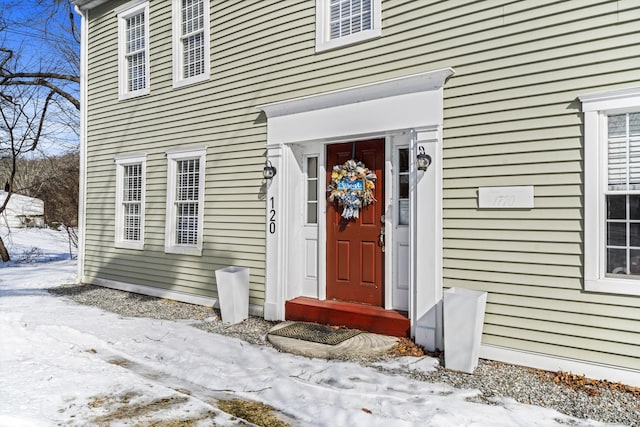 view of snow covered property entrance