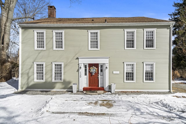 colonial inspired home featuring a chimney