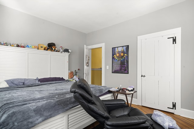 bedroom featuring wood finished floors and baseboards