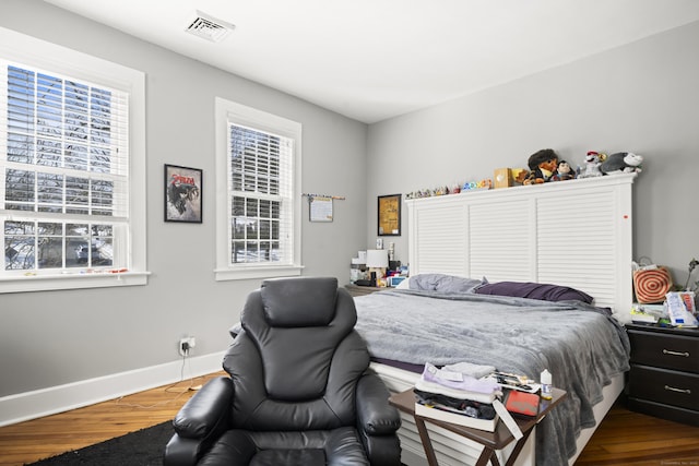 bedroom featuring dark wood finished floors and baseboards