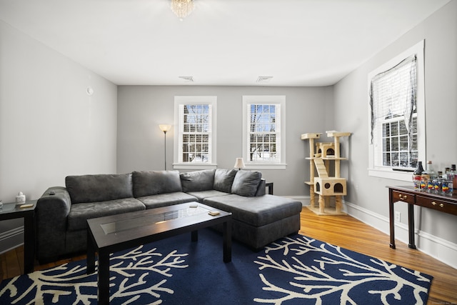 living area with wood finished floors and baseboards