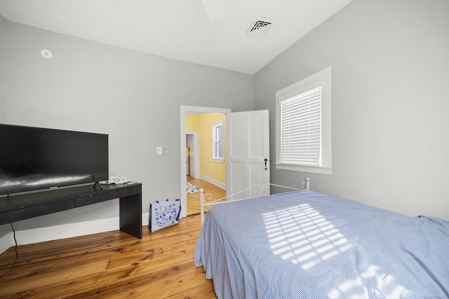 bedroom with light wood-style flooring and baseboards