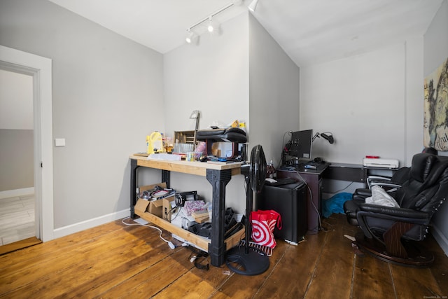 misc room featuring an office area, rail lighting, hardwood / wood-style flooring, and baseboards