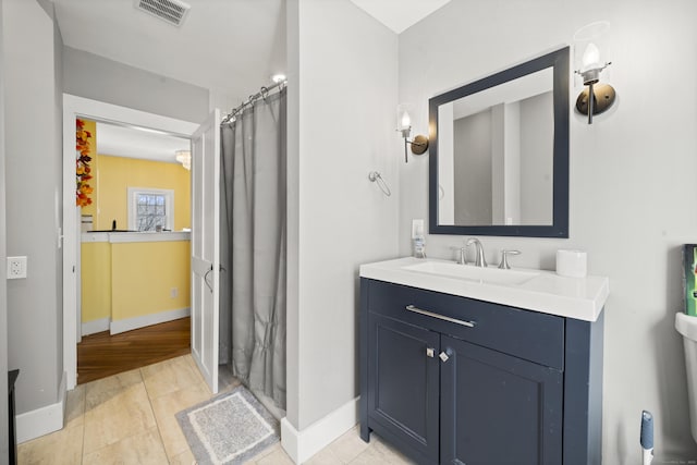 bathroom with baseboards, vanity, and a shower with curtain