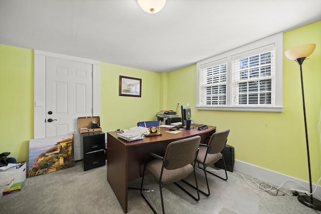carpeted home office with baseboards