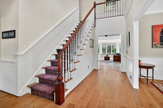207 Great Pond Rd, Simsbury, CT 06070 - stairway featuring wood finished floors, a wainscoted wall, and crown molding