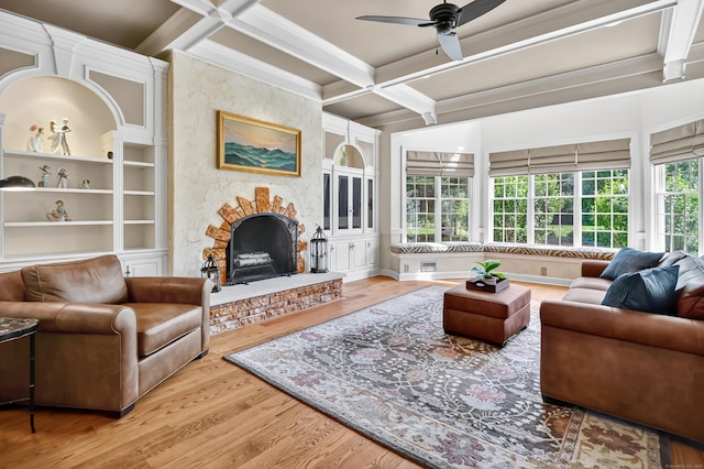 207 Great Pond Rd, Simsbury, CT 06070 - living area featuring coffered ceiling, a fireplace, wood finished floors, a ceiling fan, and beamed ceiling